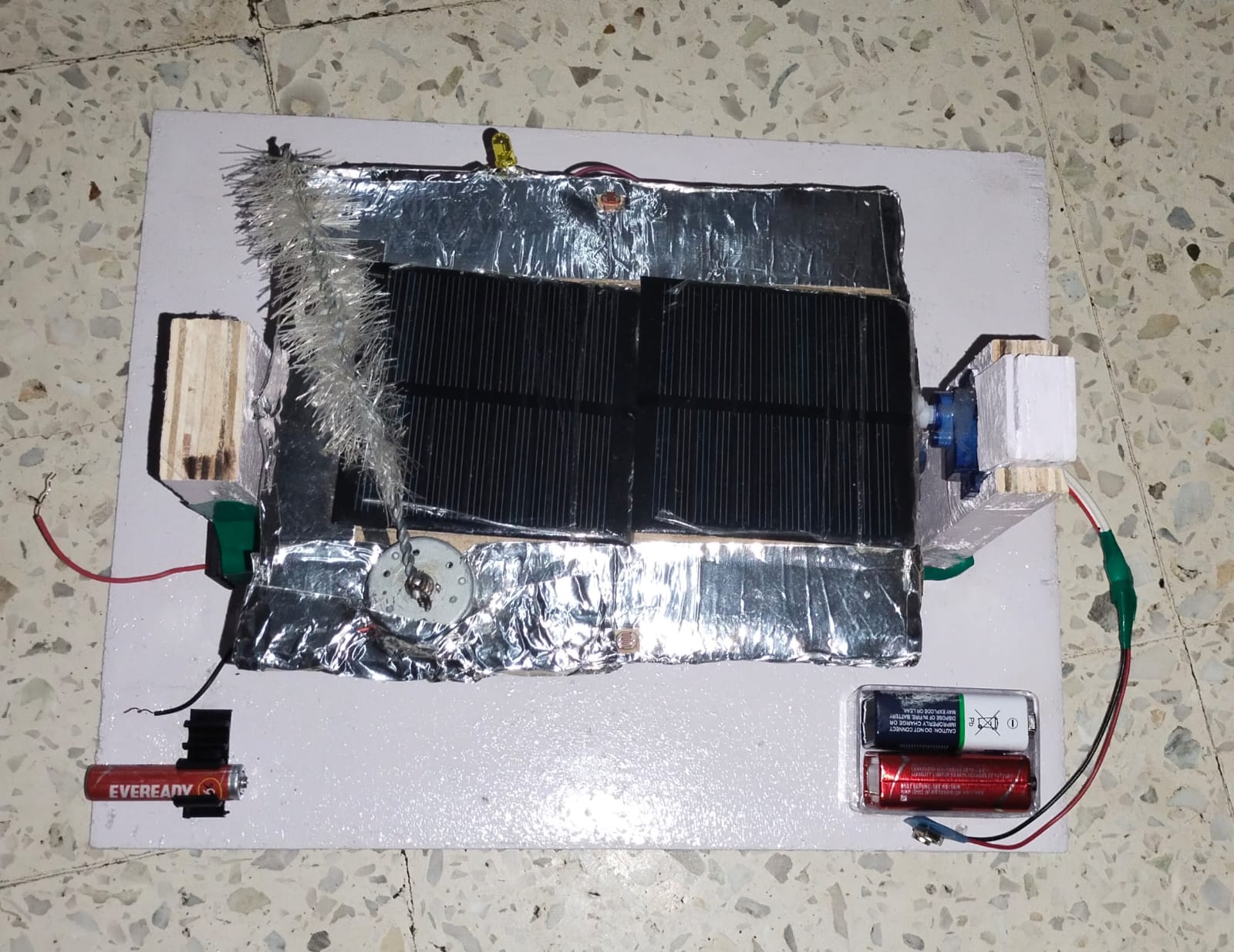 Complete prototype layout with solar panel, motor, cleaning brush, and battery system